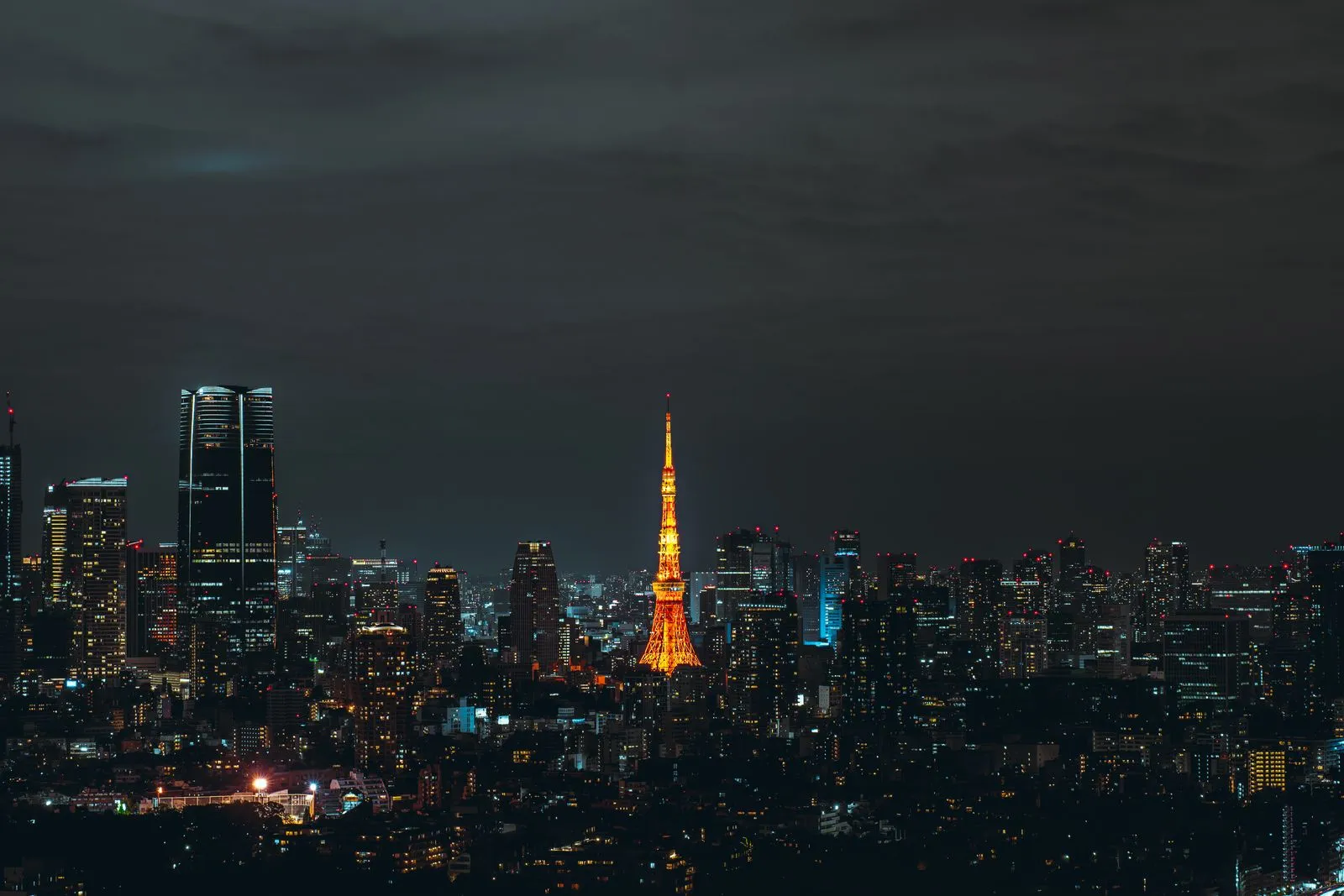 Tokyo Tower and the city's skyline illuminated at night in Tokyo, Japan.