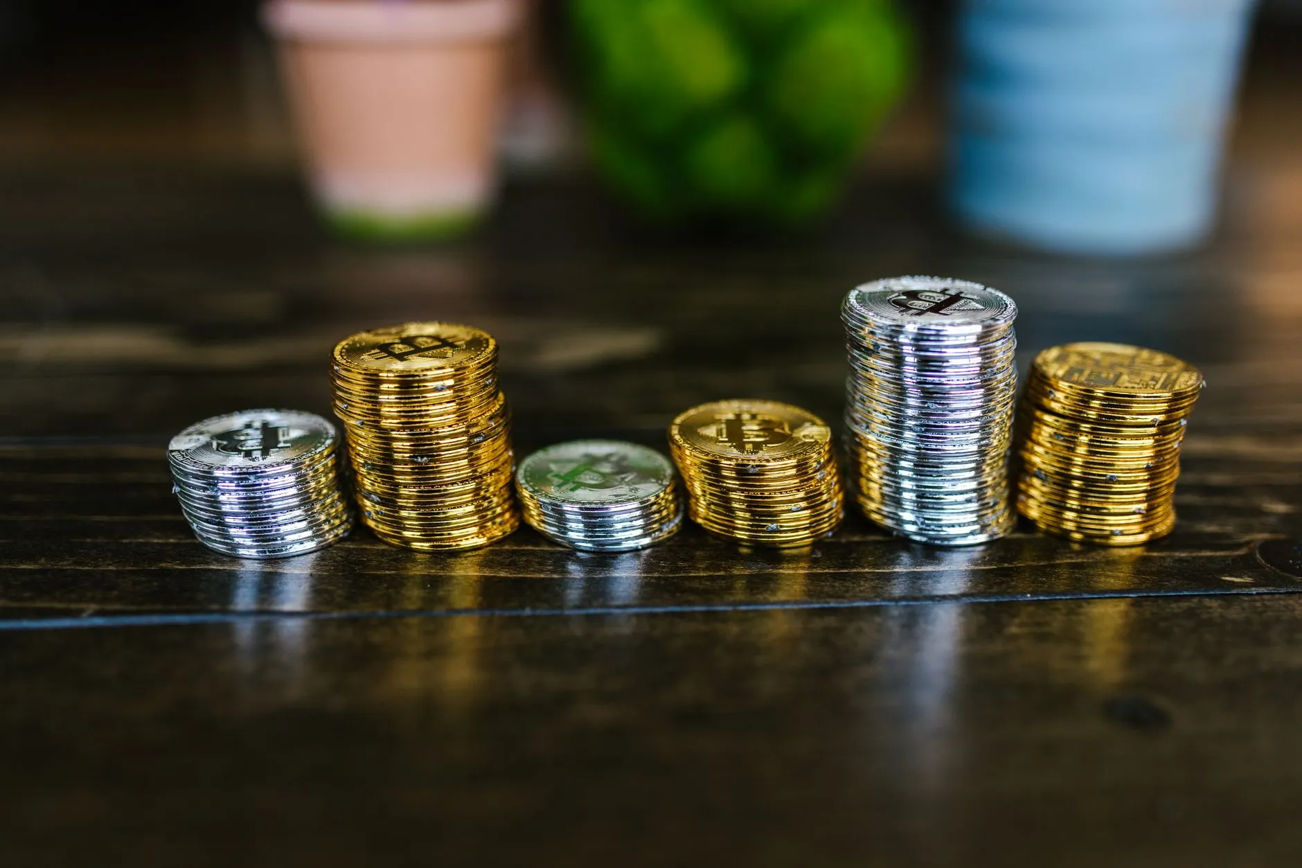 A stack of assorted cryptocurrency coins, illustrating divergent performance across top-25 assets.