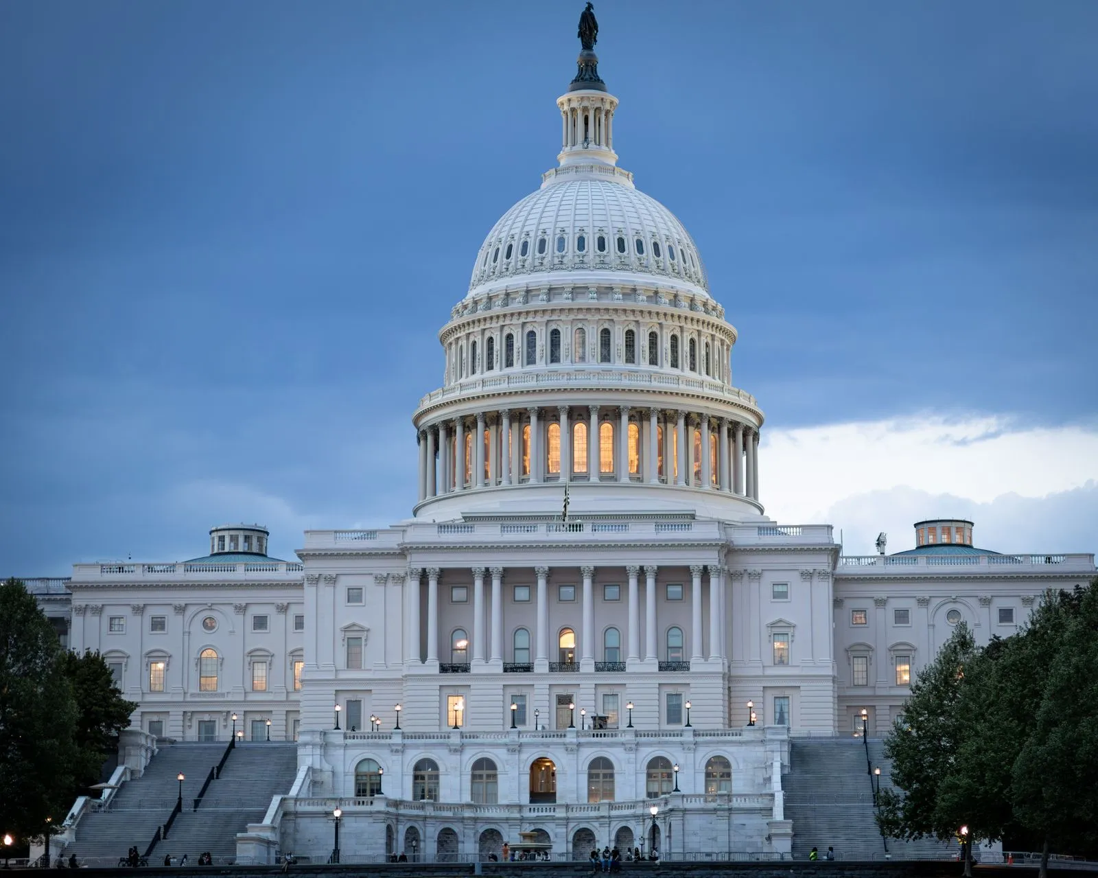 The United States Capitol dome illuminated against a twilight sky in Washington, D.C.