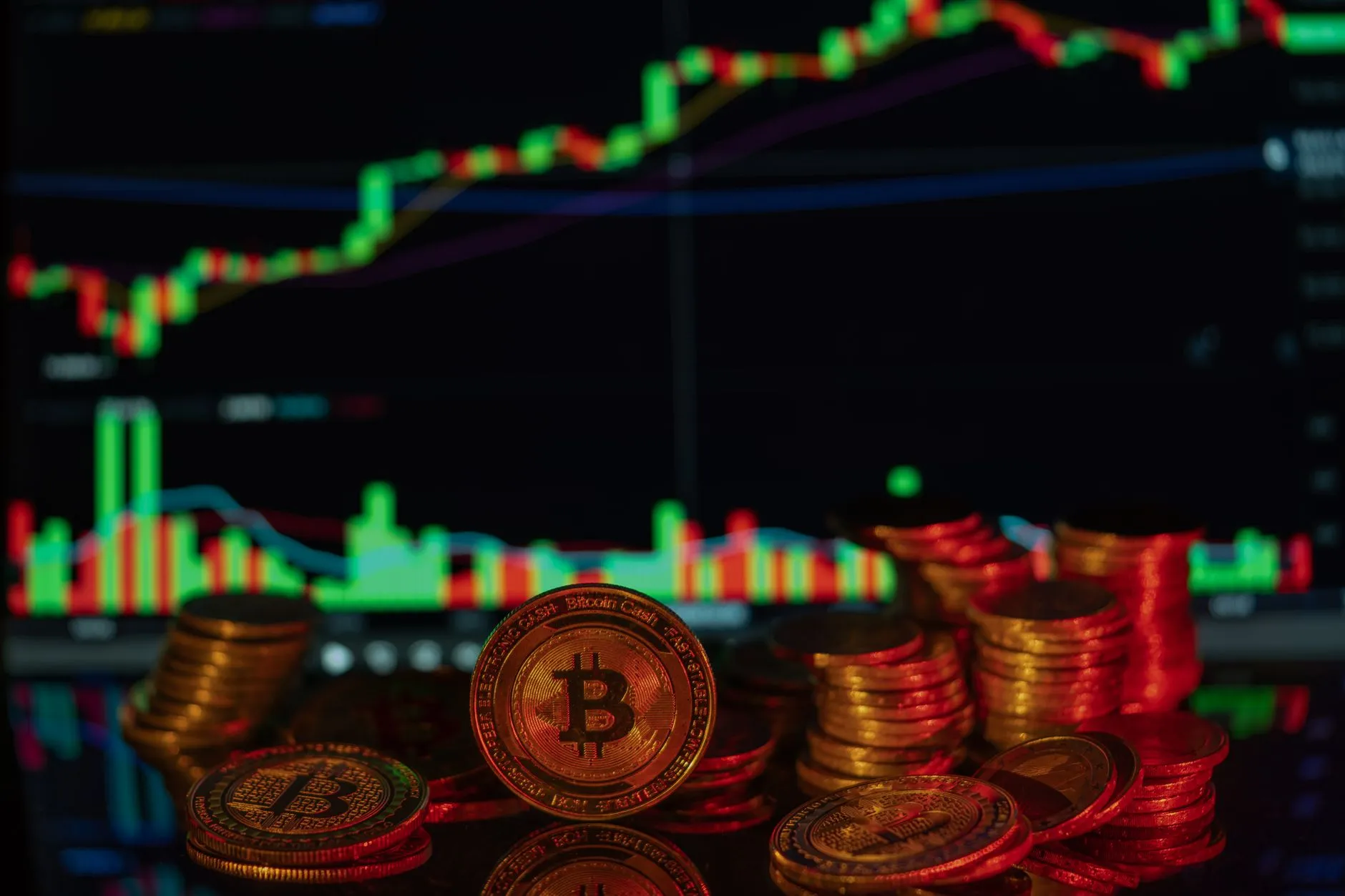 Cryptocurrency coins next to a rising chart, illustrating market capitalization measurements.