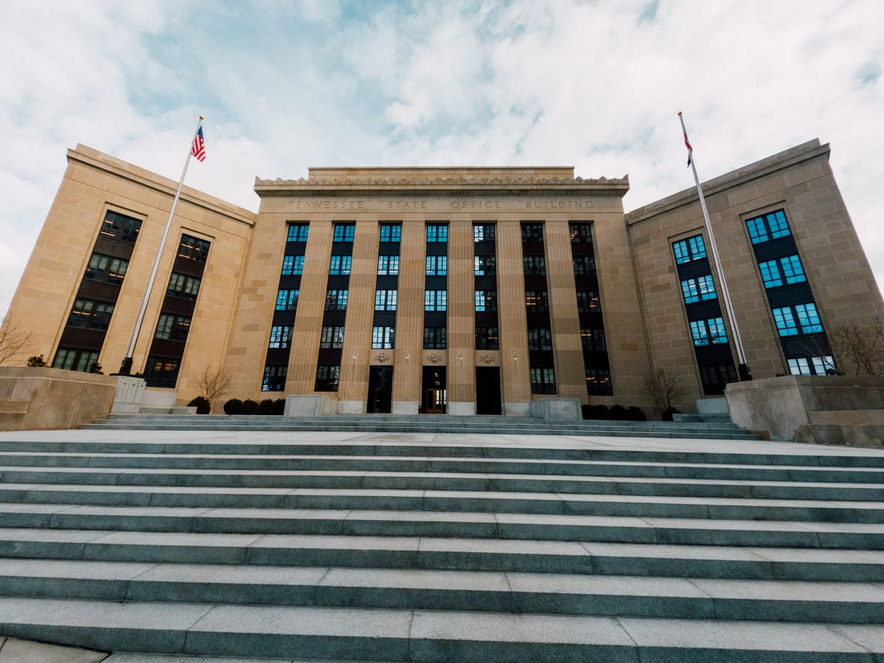 Federal Reserve building exterior with US flags and a staircase.